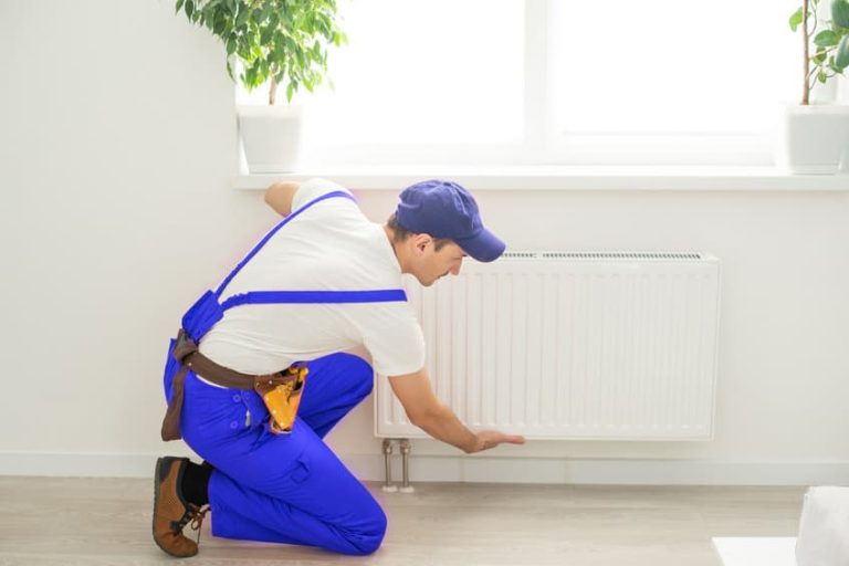 Plombier chauffagiste en action, ajustant un système de chauffage moderne