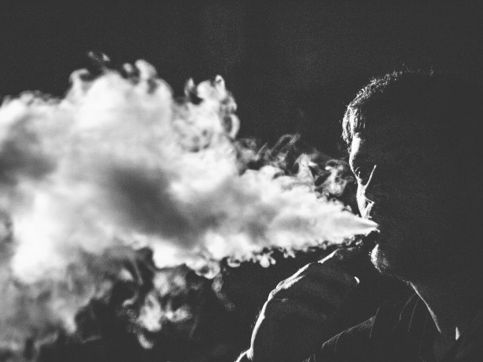 grayscale photography of smoking man