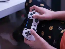 person holding white sony ps 4 controller